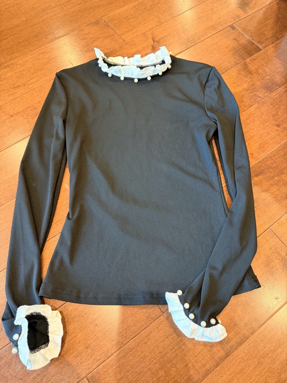 Black Long-Sleeve Top with White Ruffle Trim and Pearl Buttons